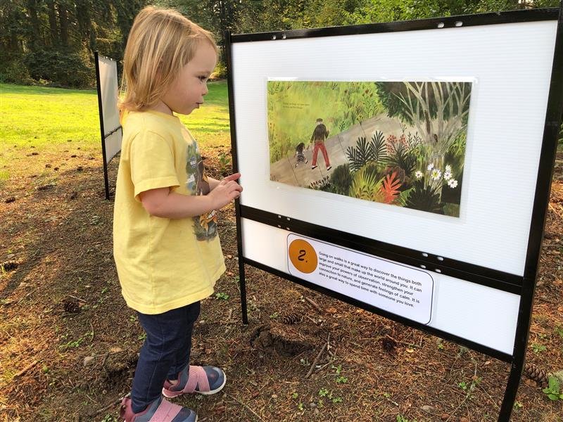 A young reader visits the Timberland Regional Library Story Trail at Decatur Woods Park in 2020.
